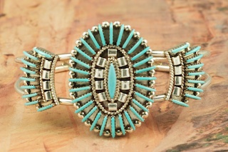 Genuine Sleeping Beauty Turquoise set in Sterling Silver Bracelet. Beautiful Needle Point Design. The Sleeping Beauty Turquoise mine is located in Gila County, Arizona. Created by Zuni Artist Edmond Cooeyate. Signed by the artist. The Zuni Pueblo is located in New Mexico, Land of Enchantment.